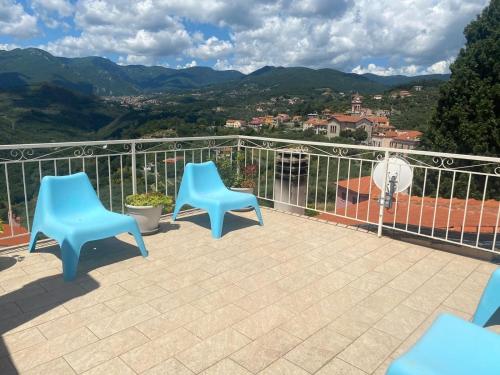 two blue chairs sitting on a balcony with a view at Rosa Di Mare Guest House in Borgio Verezzi