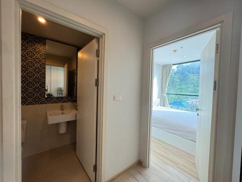 a bathroom with a sink and a mirror at The Base Height Phuket in Phuket