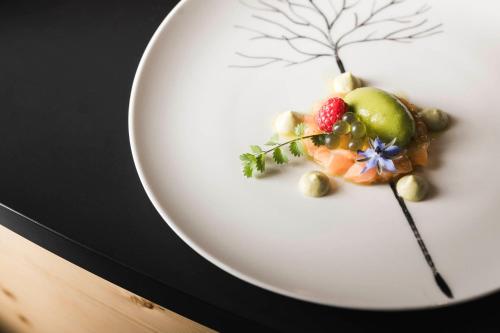 a plate of food with fruits and vegetables on it at Boutique Pension Erlacher - Adults Only in Villandro