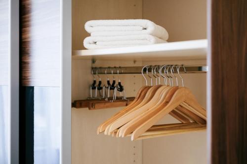 a closet with towels and utensils on a shelf at 7SCHWABEN 1 Haus 7 unterschiedliche Wohnungen alle vollausgestattet mit Küche und Bad, Waschmaschine, Altstadt 3 Minuten, Bus 3 min, Bahn 5 min, kostenloses Parken, E-Bike Garage Ladestation im Hof, E-Ladestation 3 min, rollstuhlgerecht, barrierefrei in Bad Urach