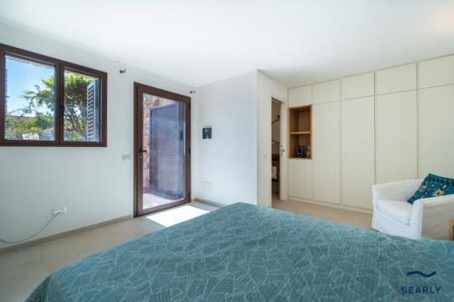 Punta MolaraVilla Piperita - By Searly的一间带床、沙发和窗户的卧室