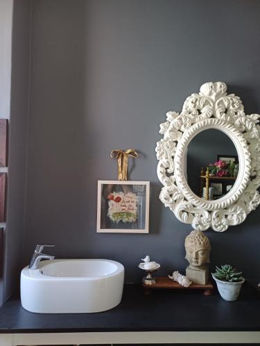a bathroom with a white tub and a mirror at GreenHouse BoKaap Stylish Apartment with Table Mountain Views in Cape Town