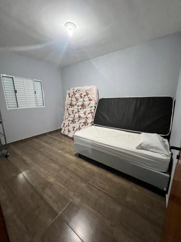 a room with a bed and a chair in it at Casa Refúgio interior -SP in São Miguel Arcanjo