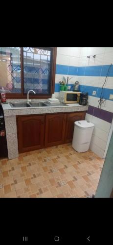 Villa de luxe LE HAVRE DE JOIE ET DE PAIX 300m2 de superficie Wifi illimité forage et grande cour pour garer plusieurs voitures ou organisation celebrations في دوالا: مطبخ فيه مغسلة ومرحاض