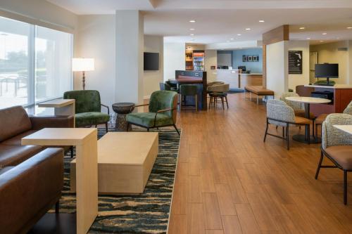 a lobby of a hospital with chairs and tables at TownePlace Suites by Marriott Lakeland in Lakeland