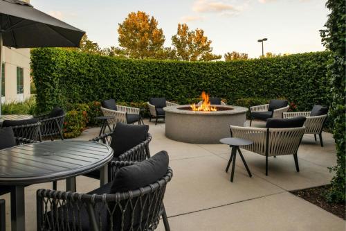a patio with tables and chairs and a fire pit at TownePlace Suites by Marriott Lakeland in Lakeland