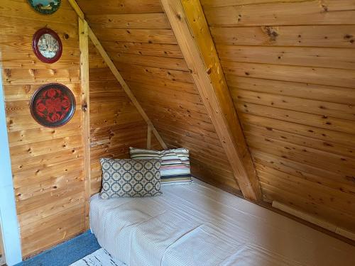 a room with a bed in a wooden attic at Ferienhütte Admont in Admont