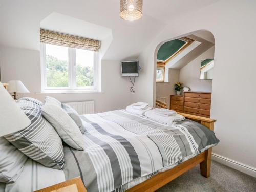 a bedroom with a bed and a mirror at Dolly Blue in Ulverston