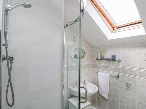 a bathroom with a shower and a sink at Dolly Blue in Ulverston