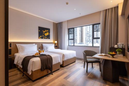 Ένα ή περισσότερα κρεβάτια σε δωμάτιο στο Nanning Meihou Lizhi Hotel