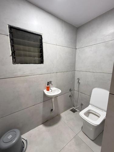 a bathroom with a toilet and a sink at Hotel castle rooms in Surat