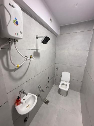 a bathroom with a sink and a toilet at Hotel castle rooms in Surat