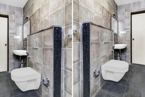 a bathroom with two toilets and two sinks at 5BHK AC Villa call 8O882 - 37972 in Mysore