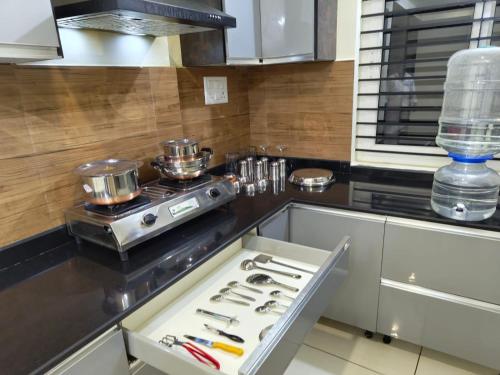 a kitchen with a stove and a counter top at 5BHK AC Villa call 8O882 - 37972 in Mysore