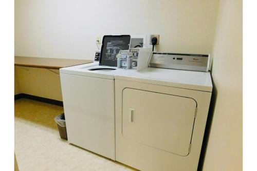 a white washer and dryer in a room at Homestead Inn Wolf Point Hwy 2 in Wolf Point