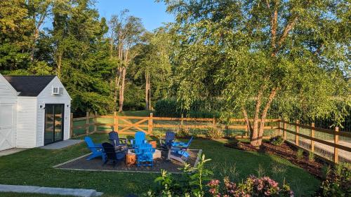 a yard with blue chairs and a fence at Berrywood Cottage in Lakeside
