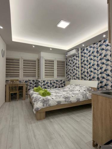 a bedroom with a bed and a desk in it at CS Apartment in Skopje