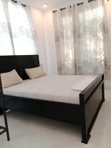 a bed in a room with a large window at Hidalgo Home Apartment's in Moshi