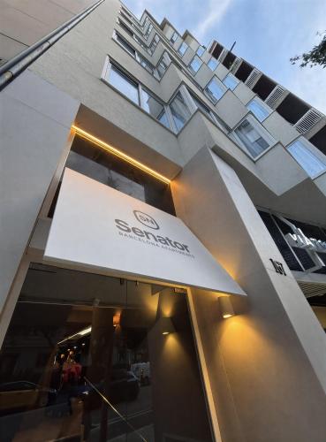 a building with a sign on the front of it at Senator Barcelona Apartments in Barcelona