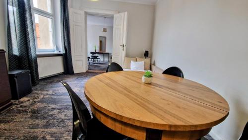 a wooden table in a room with chairs around it at Kamienica Bankowa Residence in Poznań