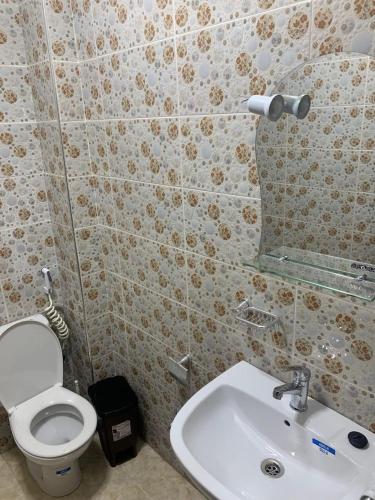a bathroom with a toilet and a sink at Résidence Atlantic in Agadir