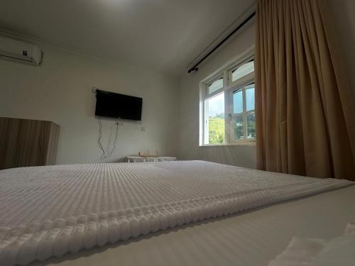 Ένα ή περισσότερα κρεβάτια σε δωμάτιο στο Cloud Nest Hanthana