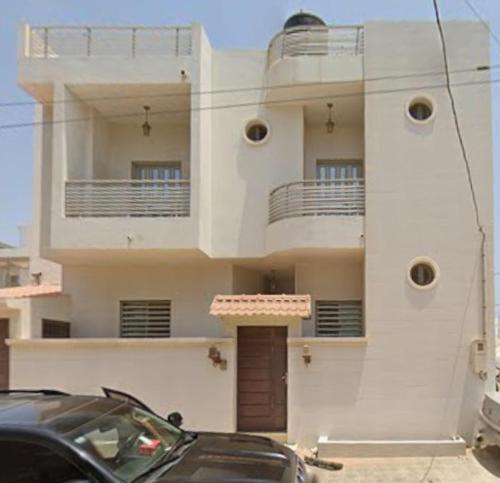 a black car parked in front of a building at Yoff Oasis Duplex in Dakar
