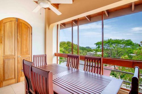 a dining room with a table and chairs on a balcony at Tropical Condo with Spectacular Ocean Views, Panoramic Dining Terrace & Quick Walk to Beach in Coco