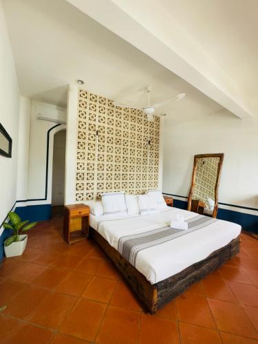a bedroom with a large bed in a room at Hotel Tulum Centro, Party Hotel in Tulum