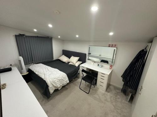 a bedroom with a bed and a desk and a mirror at Stort luksus Villa in Søborg