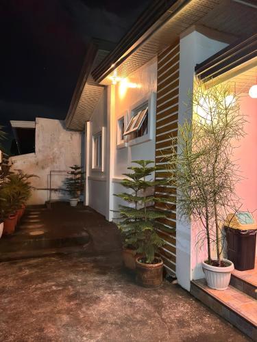 a house with plants on the side of it at night at Casa Tres16 - Your Private Cozy Retreat in Pilar