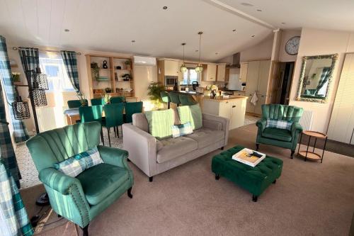 a living room with a couch and chairs and a kitchen at Meadows 90 - Southview Holiday Park Skegness in Skegness