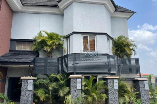 a building with palm trees in front of it at Brava Hotel in Ibadan