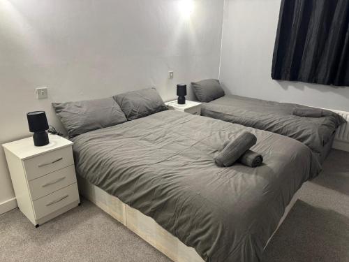 a bedroom with two beds and two night stands at East Croydon Comfort Apartments in Croydon