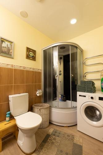 a bathroom with a toilet and a washing machine at Apartment Amber Riga in Riga