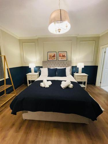 a bedroom with a large bed with two towels on it at Eurobar & Hotel in Oxford