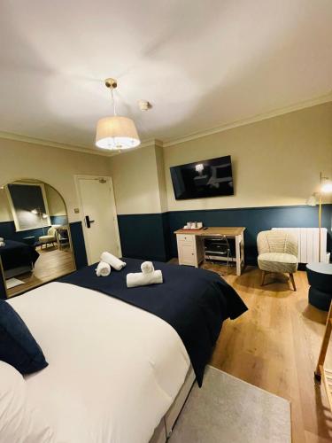 a bedroom with a large bed with two towels on it at Eurobar & Hotel in Oxford