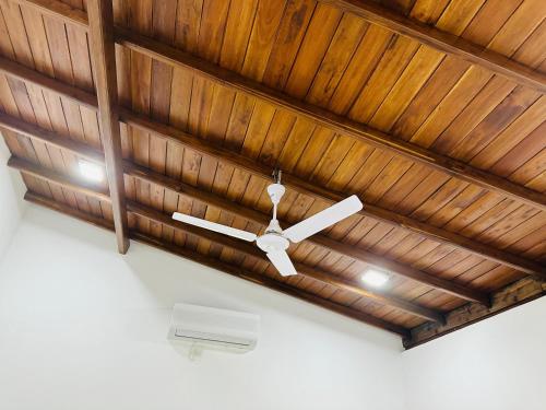 a wooden ceiling with a white ceiling fan at Villa Cinnaro in Ahangama