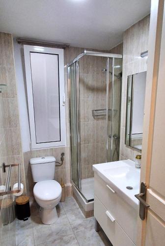 a bathroom with a toilet and a shower and a sink at Marvelous flat in the city center in Ceuta