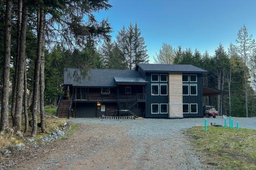 a large black house in the middle of a forest at Monarch Mine in Girdwood