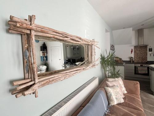 a living room with a mirror on the wall at SeaScape in Bexhill