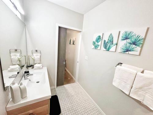 a white bathroom with a sink and a mirror at Indigo Studio in Des Moines