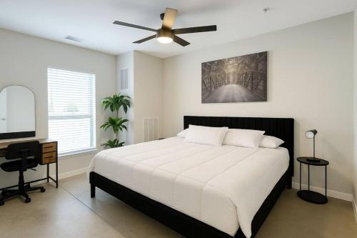a bedroom with a bed and a ceiling fan at Forestline Suite in Des Moines