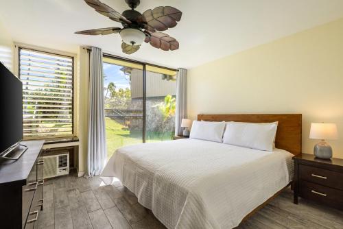 a bedroom with a bed and a ceiling fan at The Beach Nook at Turtle Bay in Kahuku