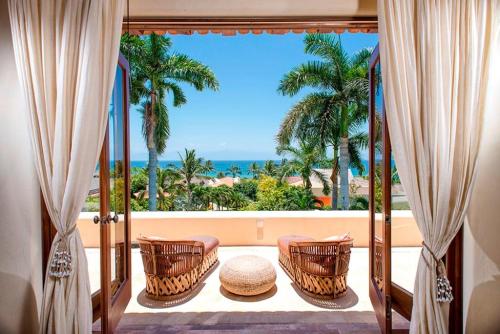 a room with a balcony with a view of the ocean at Ocean view villa- home Infinity Pool Concierge in Punta Mita