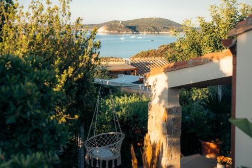 a view of the ocean from a house at Dimora Su Tramonti a due passi dal mare! in Is Traias