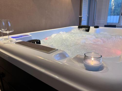 a bath tub with a candle and a candleholder in it at Avi Rooms in Chiaramonte Gulfi