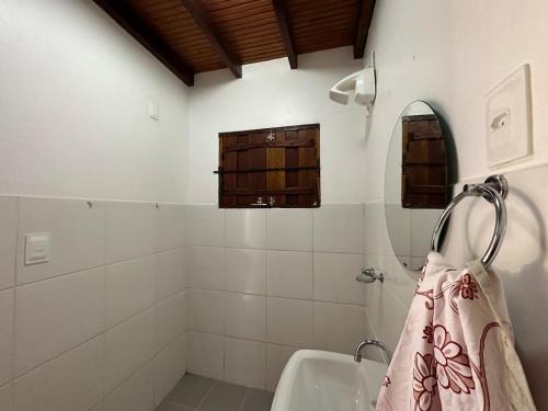 a bathroom with a sink and a shower with a towel at Atelier-homeoffice in Pirenópolis