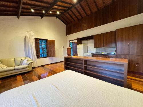a large room with a kitchen and a couch at Atelier-homeoffice in Pirenópolis