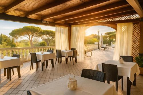 a restaurant with tables and chairs and a balcony at Villa Antonietta Ischia in Ischia